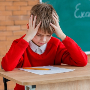 photo of a kid frustrated in class